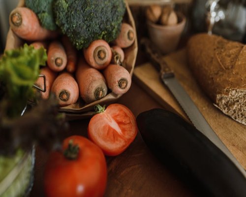 Variety of fresh vegetables and grains on a kitchen counter